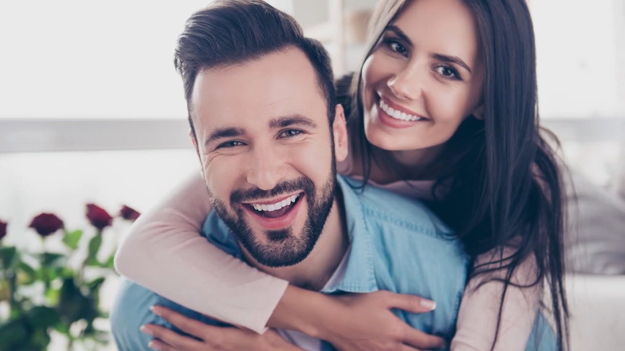Woman hugging man from behind
