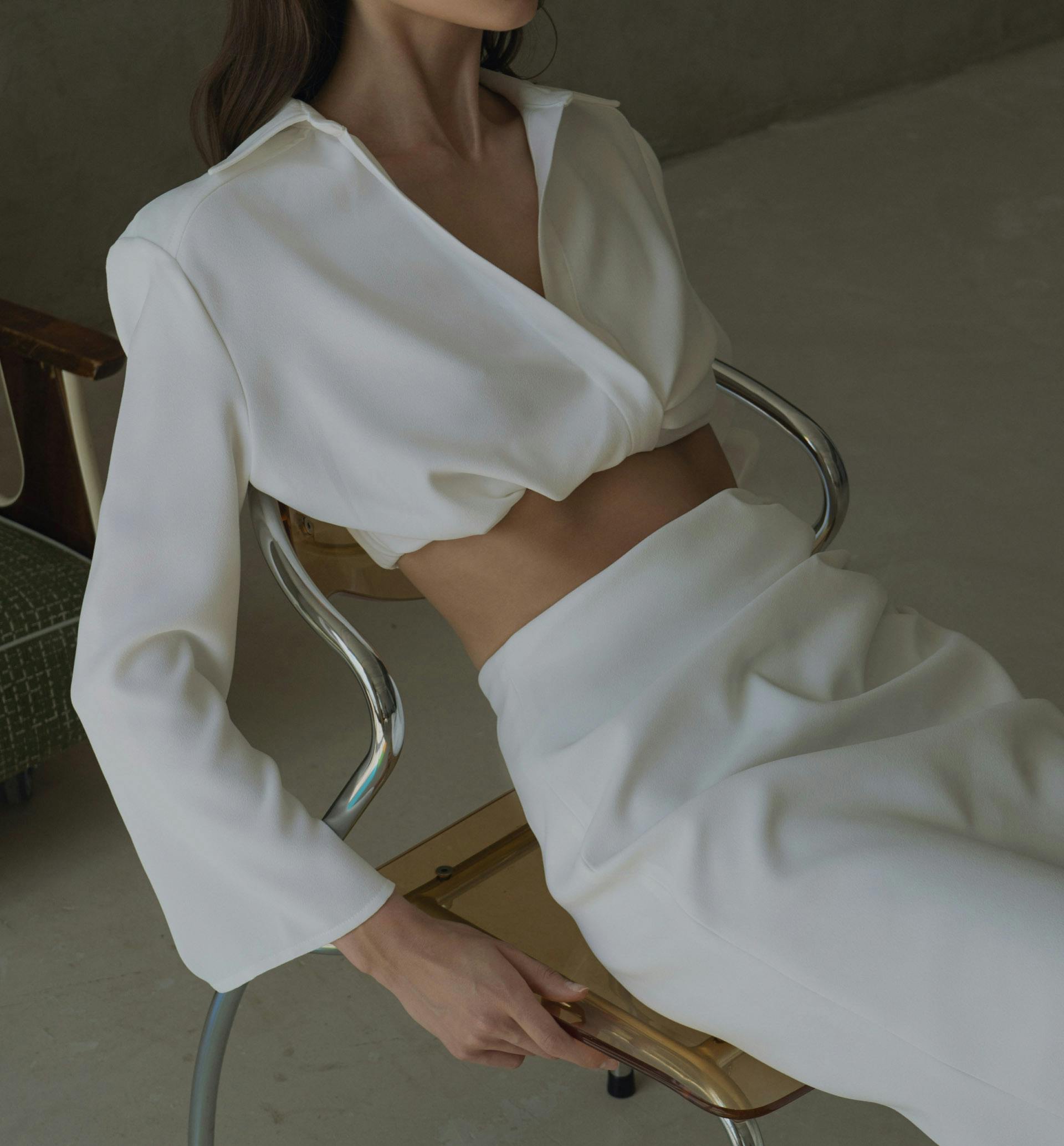 Woman in white sitting on a chair