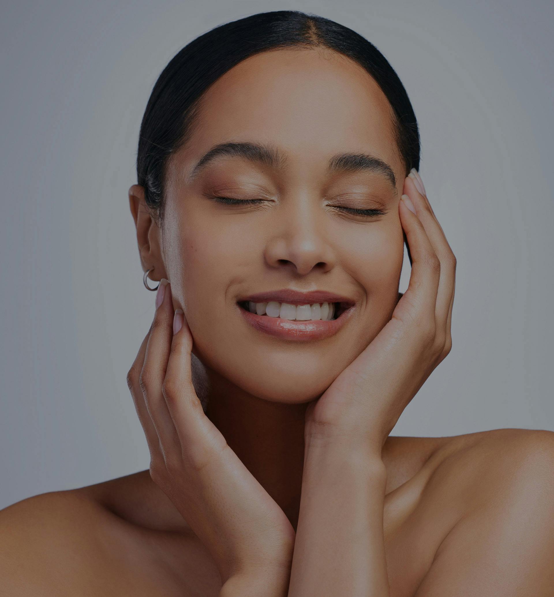 woman with eyes closed and smiling