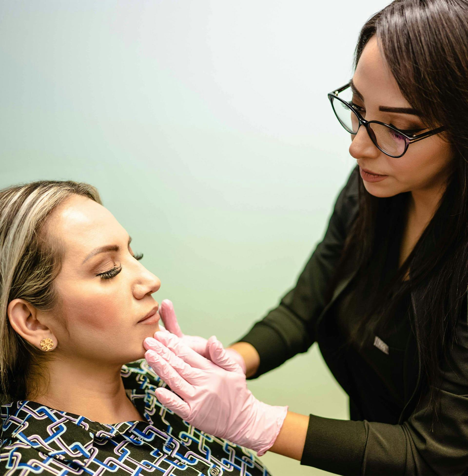 doctor touching client's chin