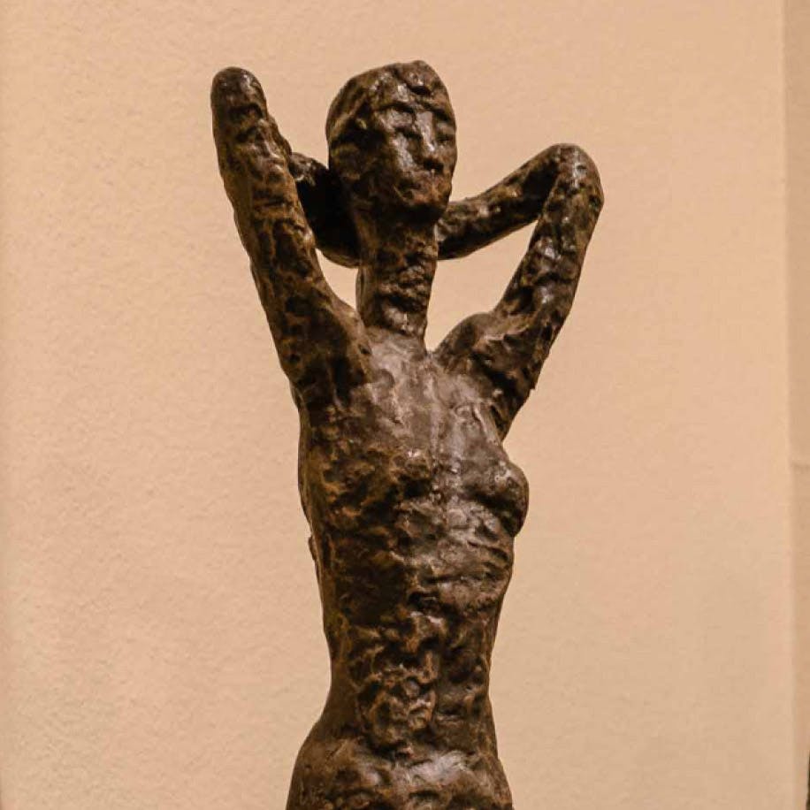 statue of person with arms behind its head