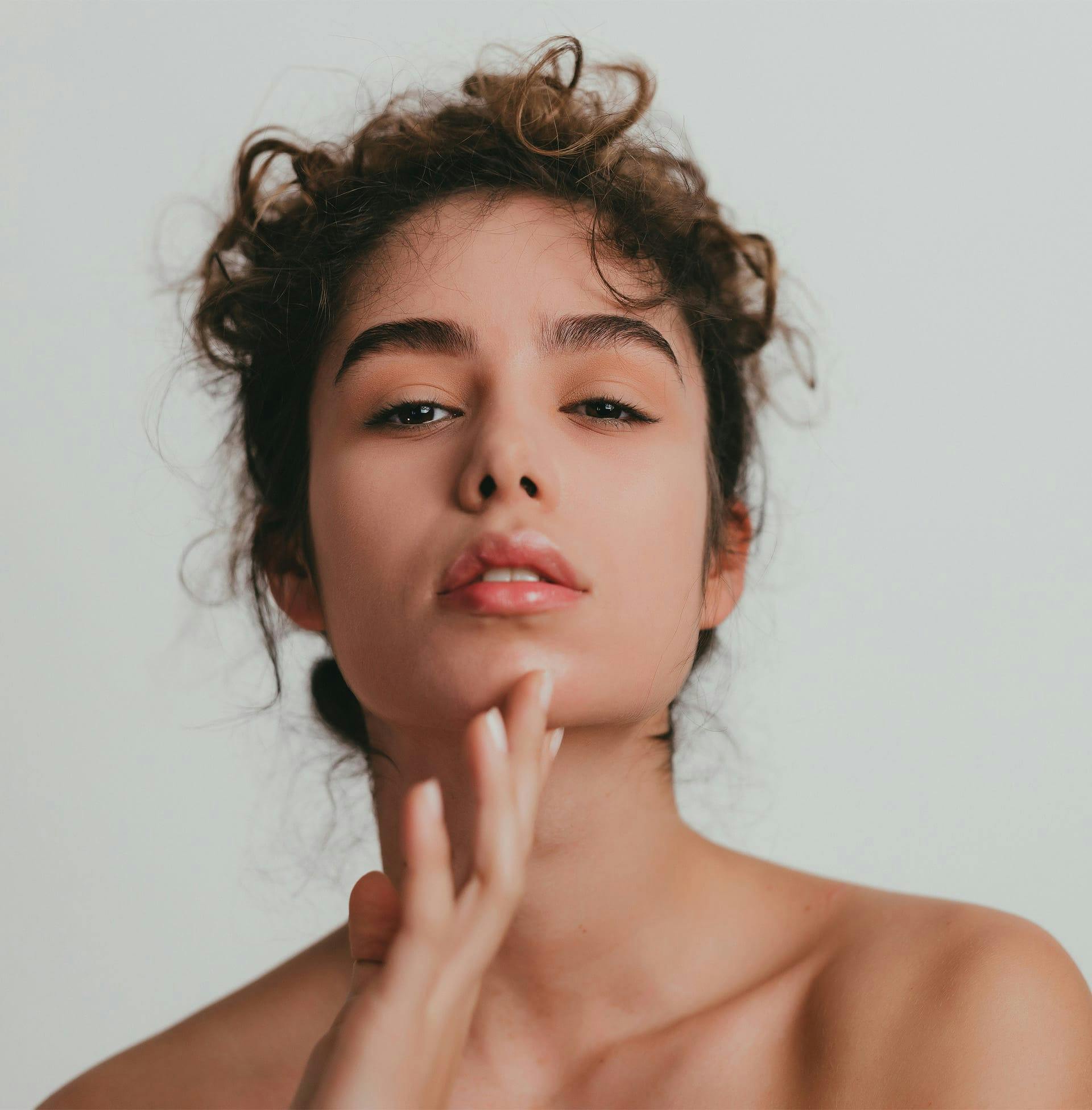 lady with curly hair tied into bun