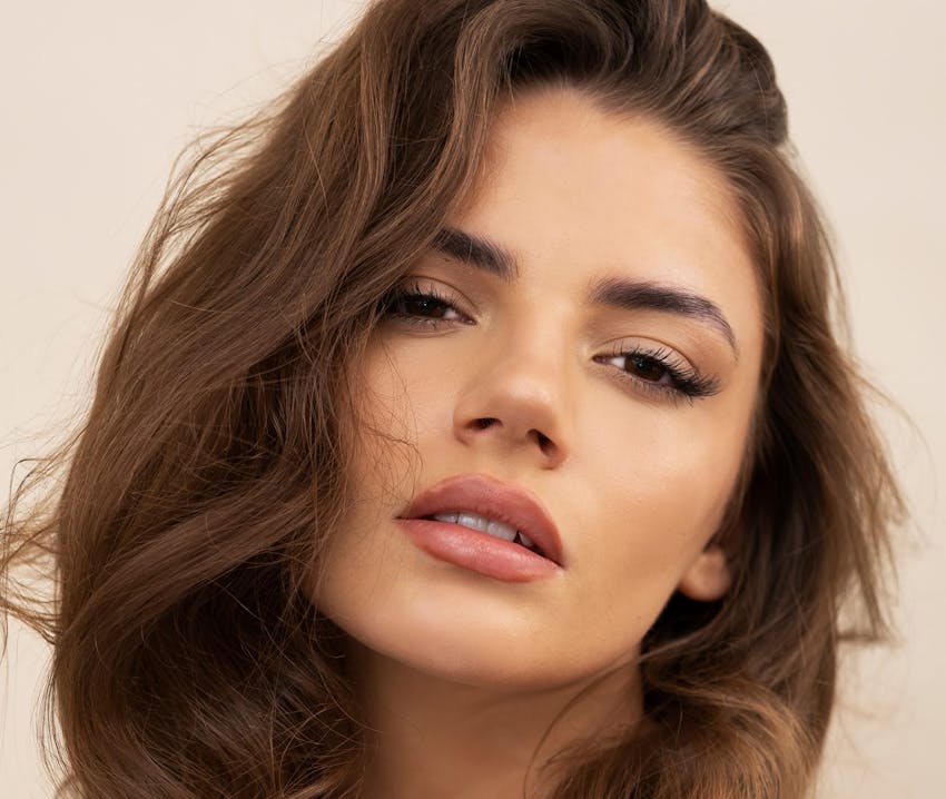 close up of woman with brown wavy hair
