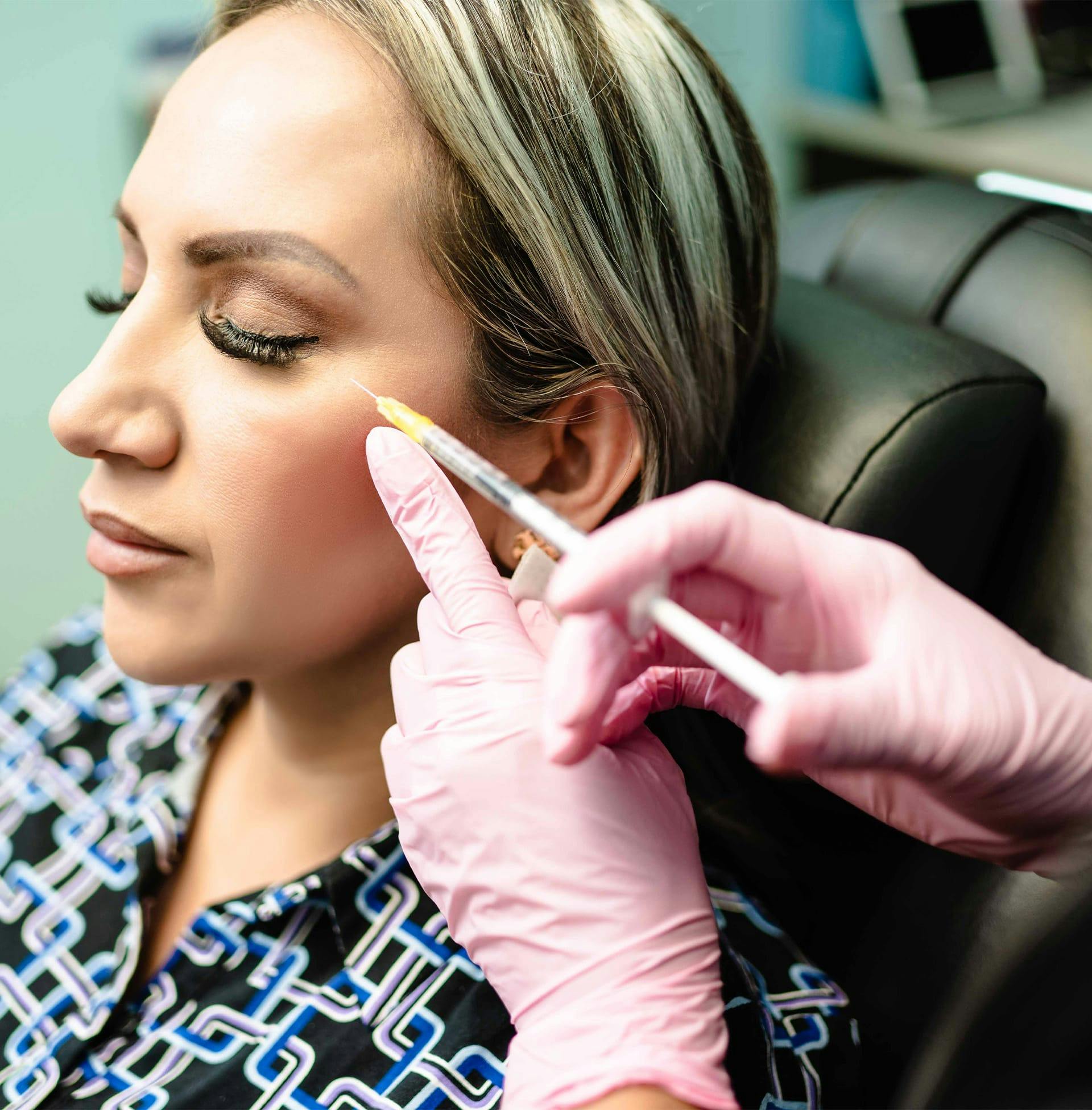 client sitting in chair about to get injection