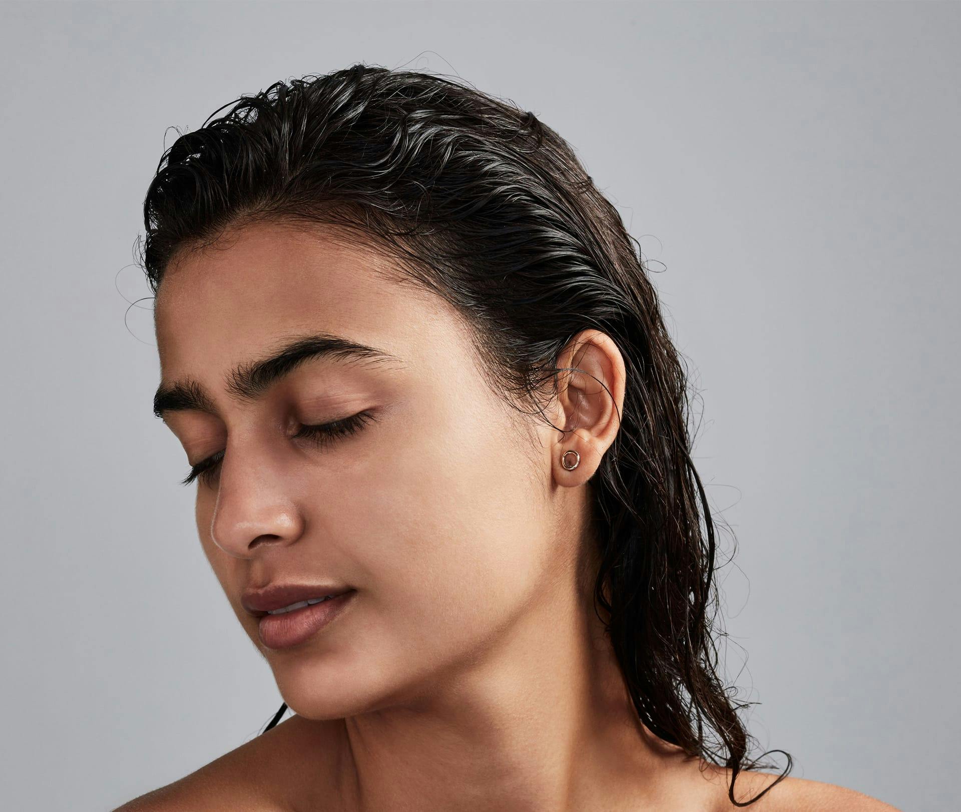 woman with wet hair looking down