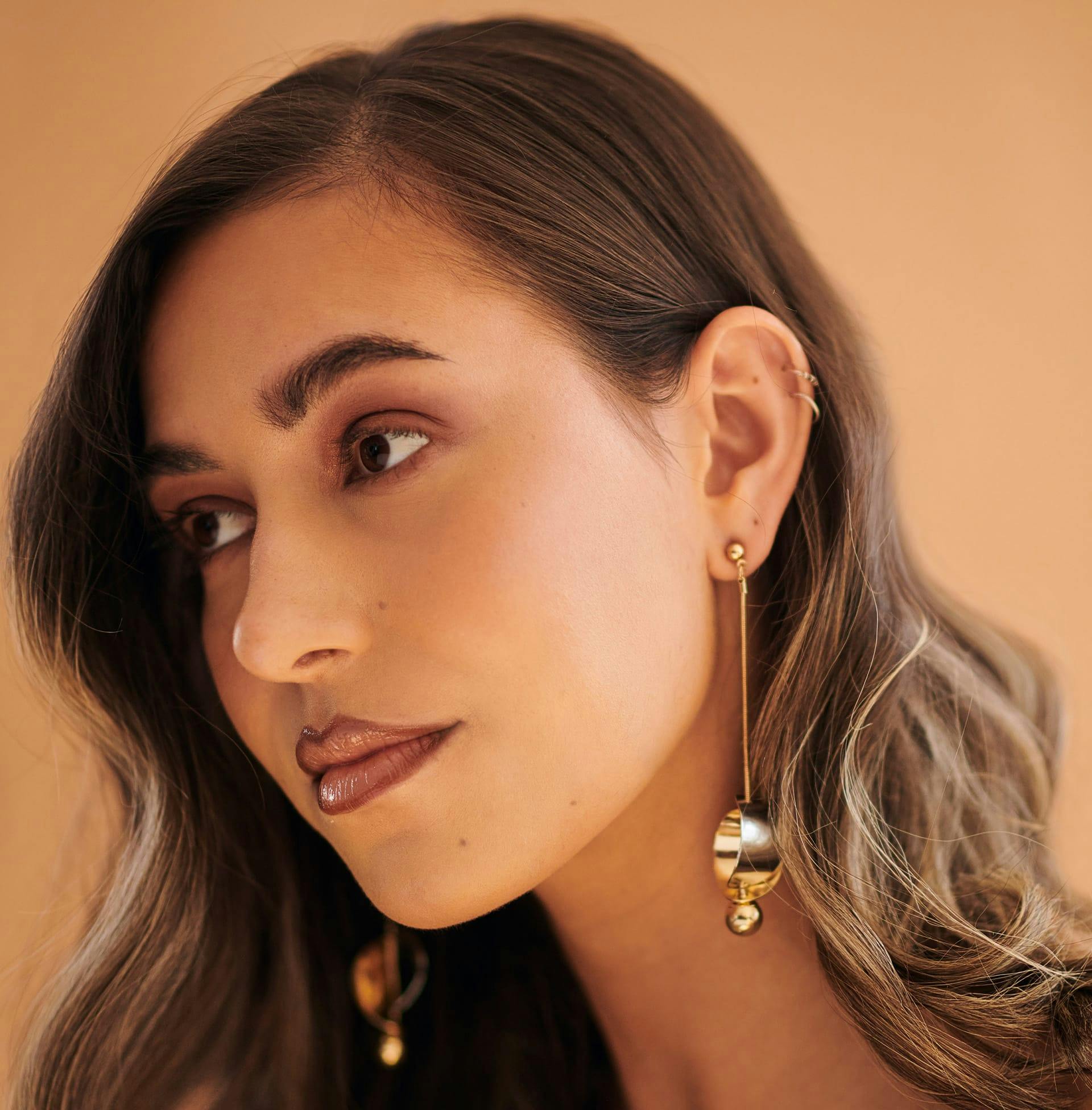 woman looking to the side showing her ear