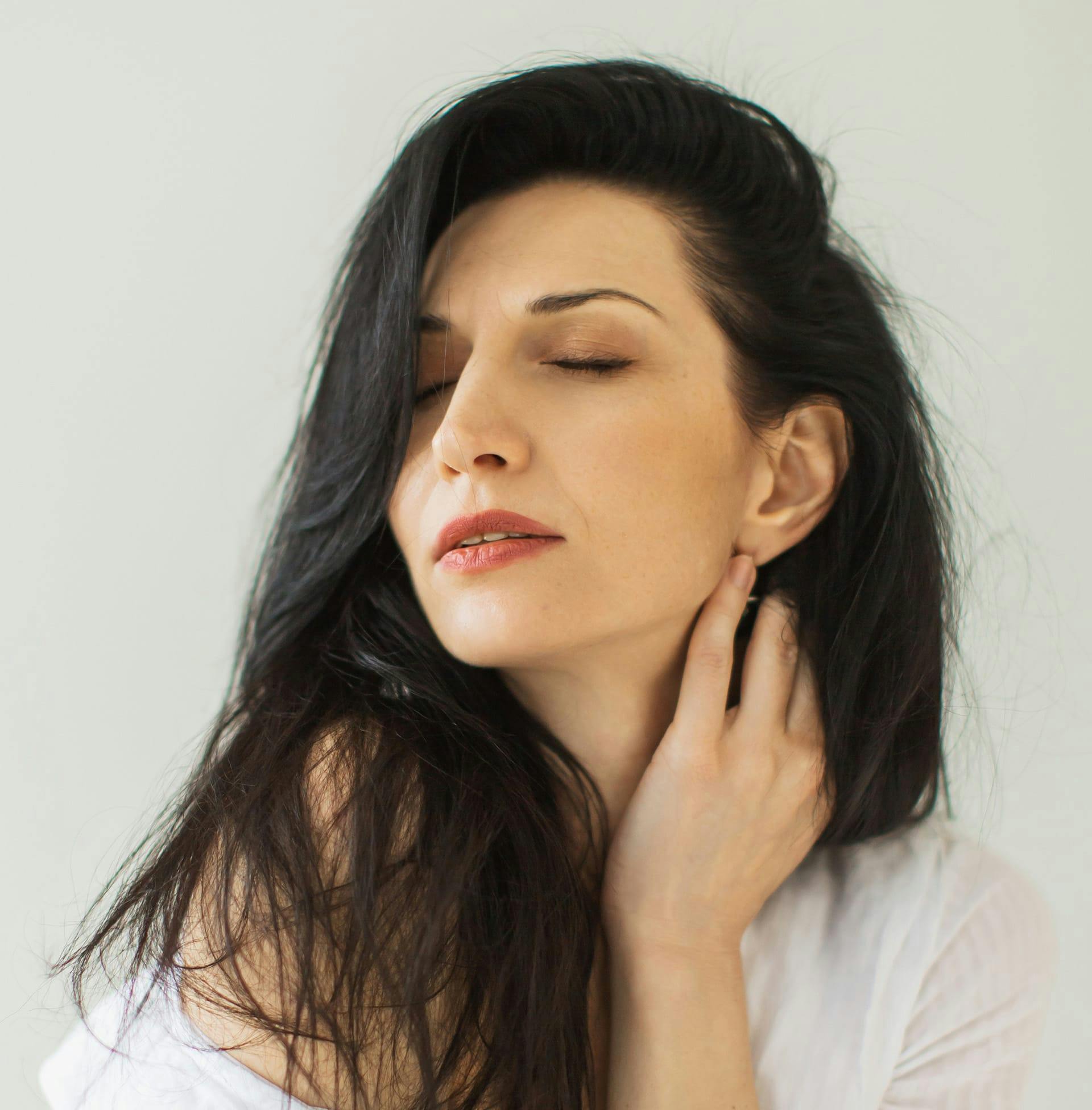 woman with eyes closed with long black hair