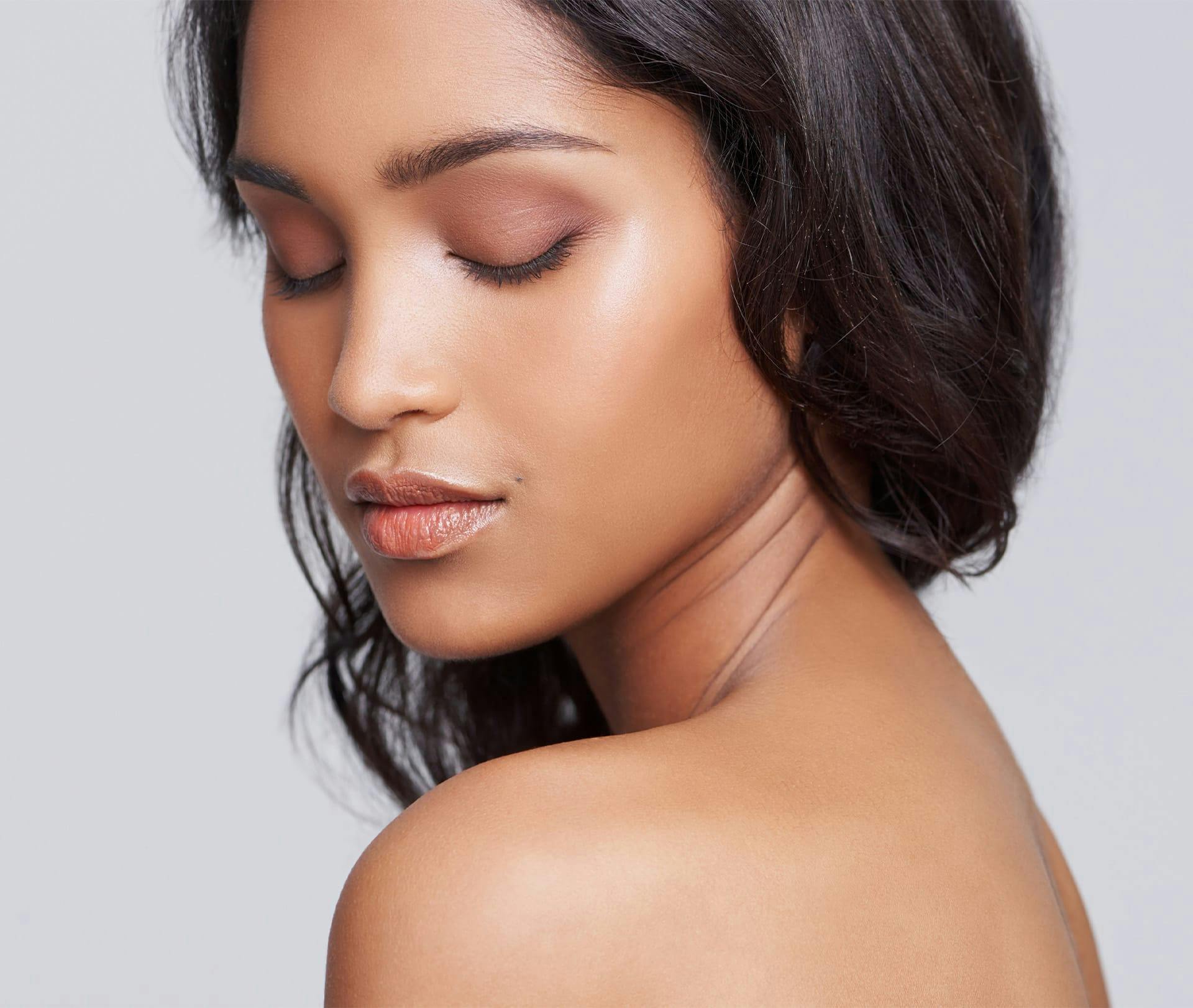 woman looking down and over her shoulder