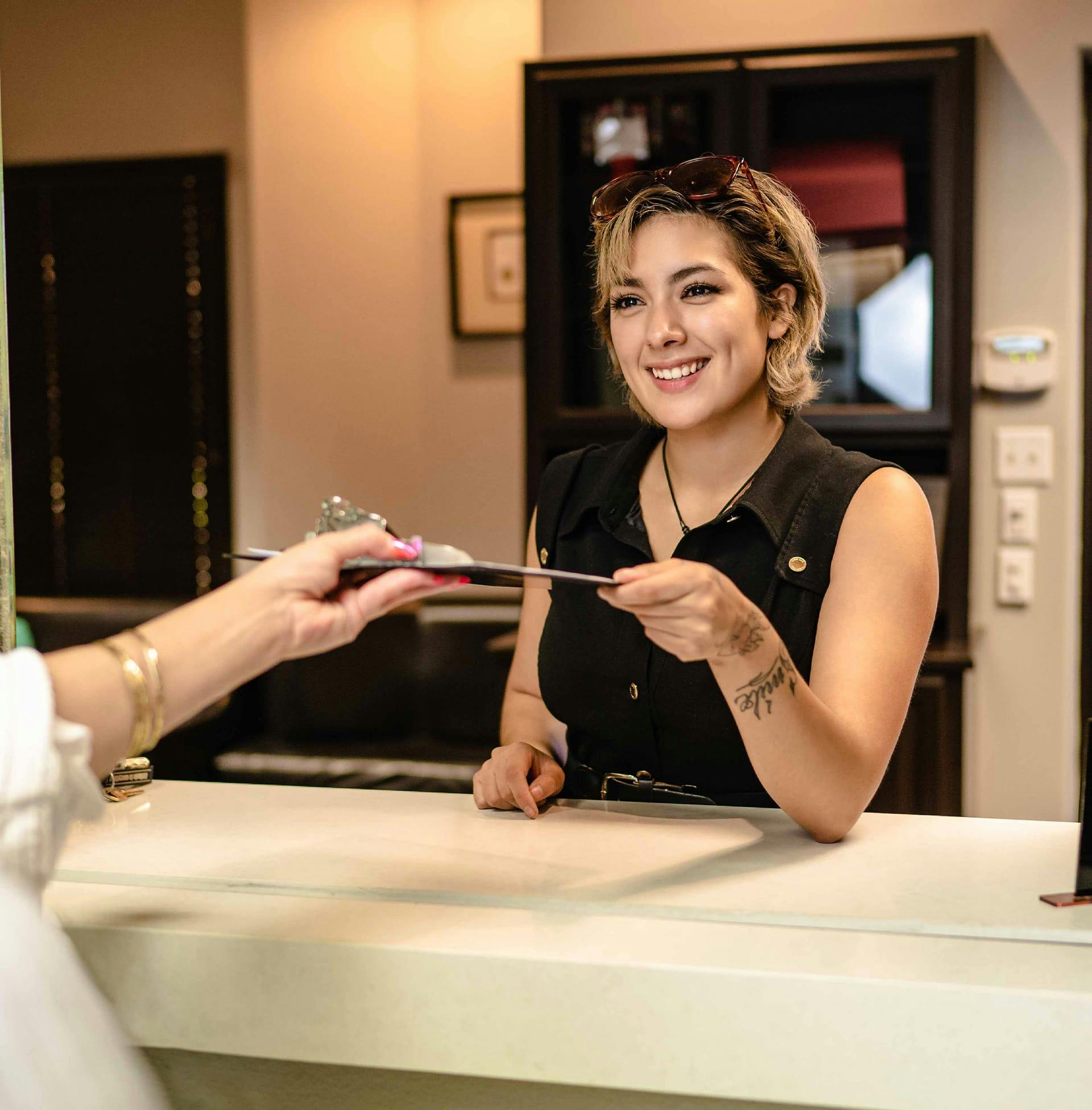 2 clients signing forms in seating room