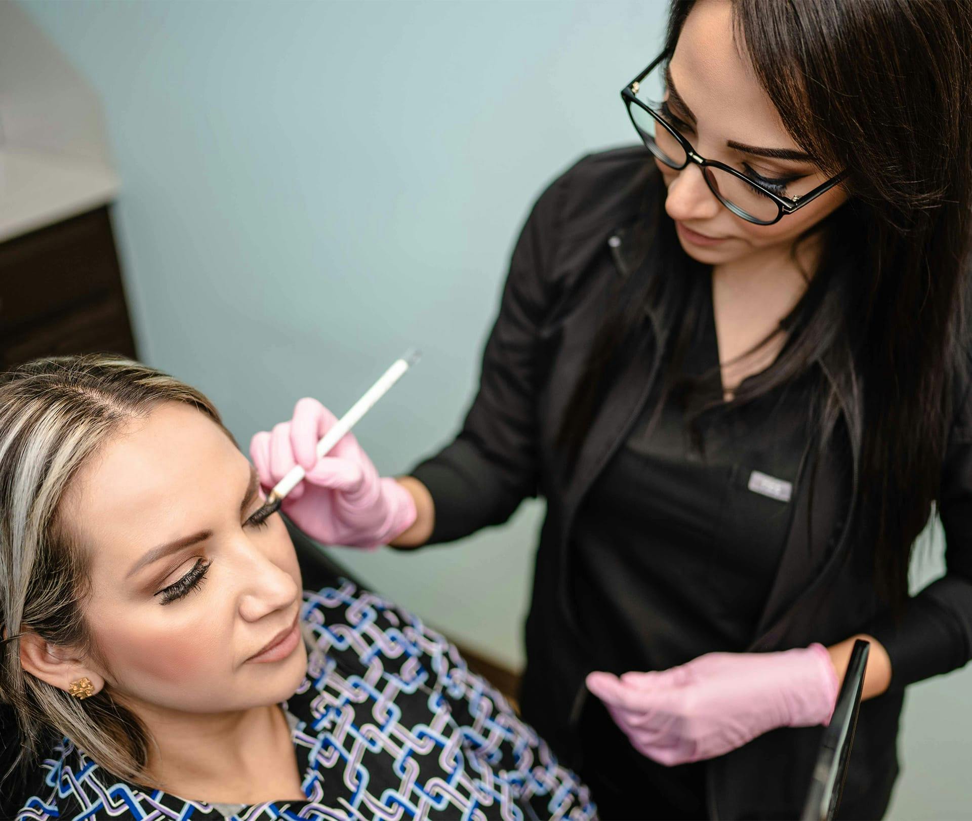 nurse drawing on clients temple area for injections