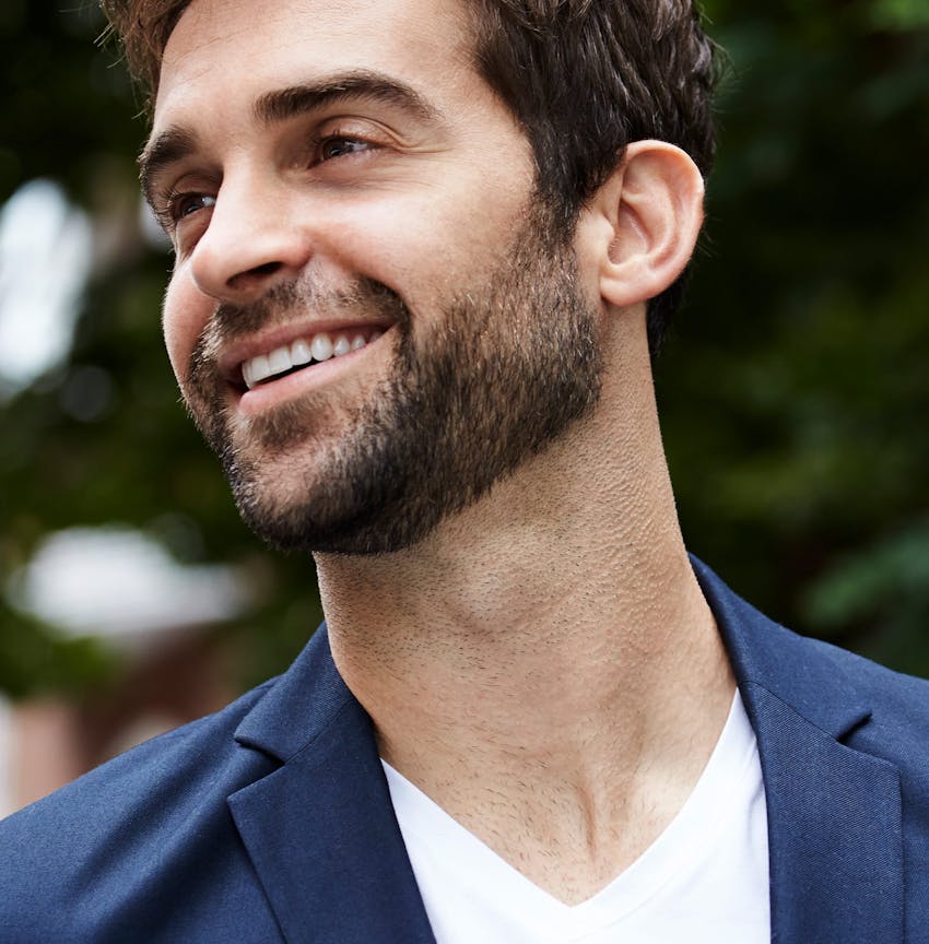 man looking off to the side in blue jacket