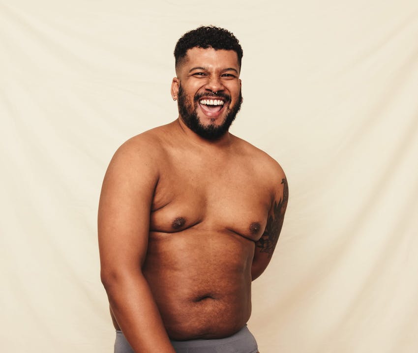 man smiling with no shirt with white background