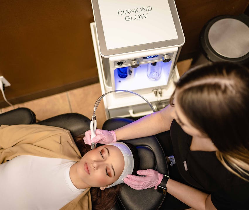 client getting microermabrasion done on her cheek