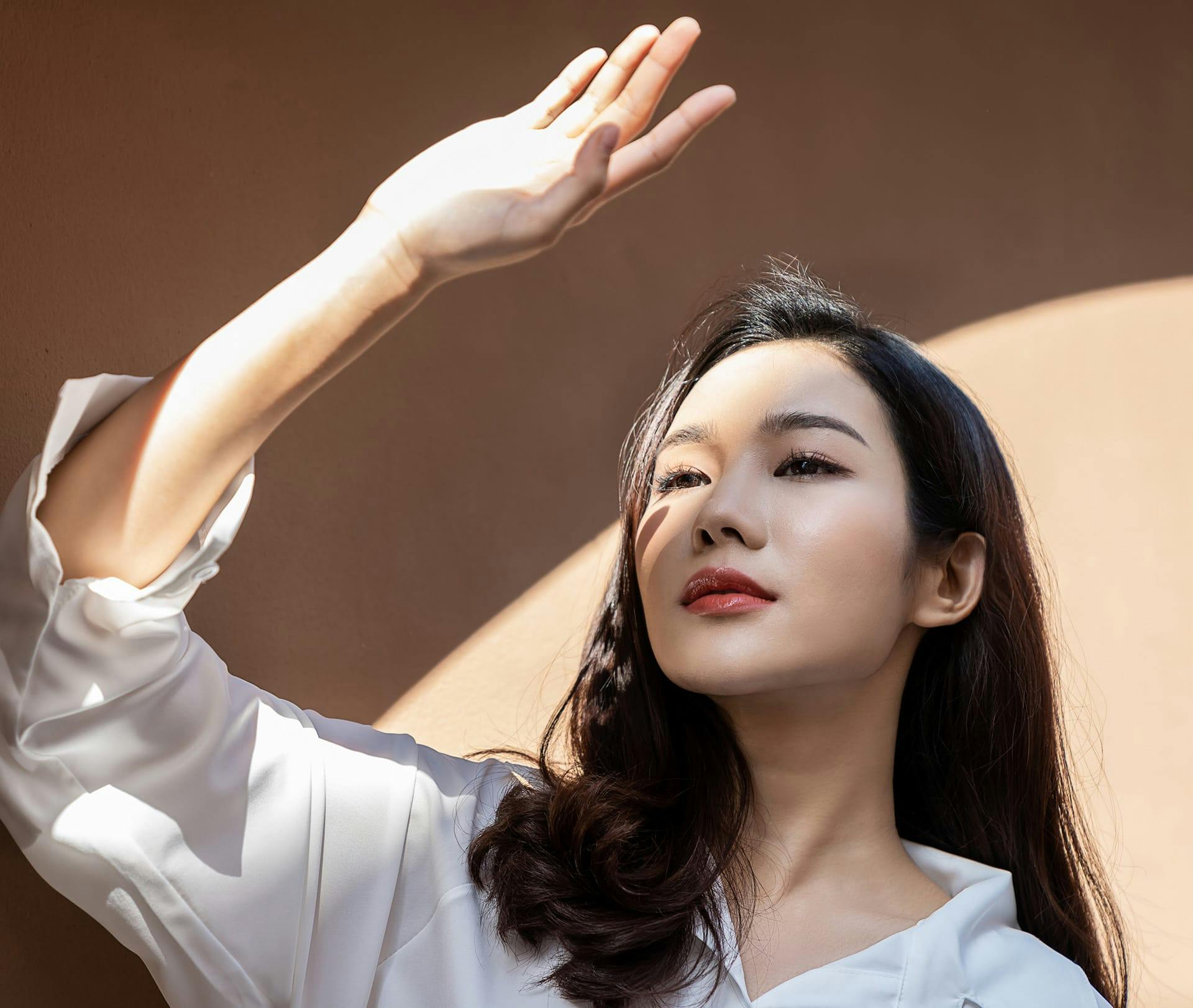 woman covering sunlight with her hand