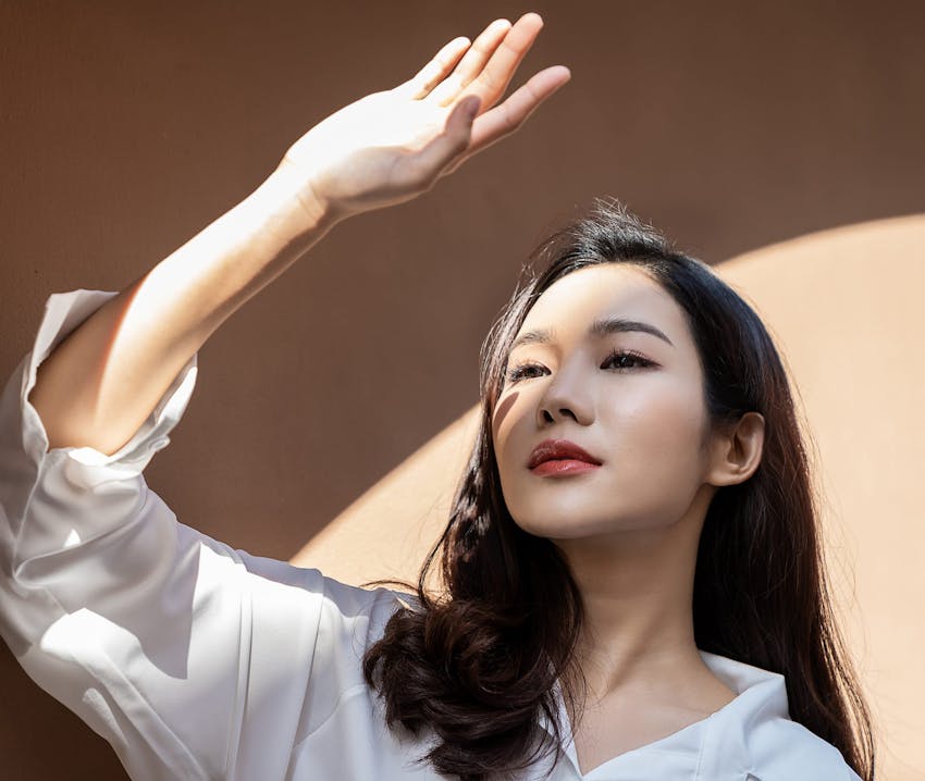 woman covering sunlight with her hand