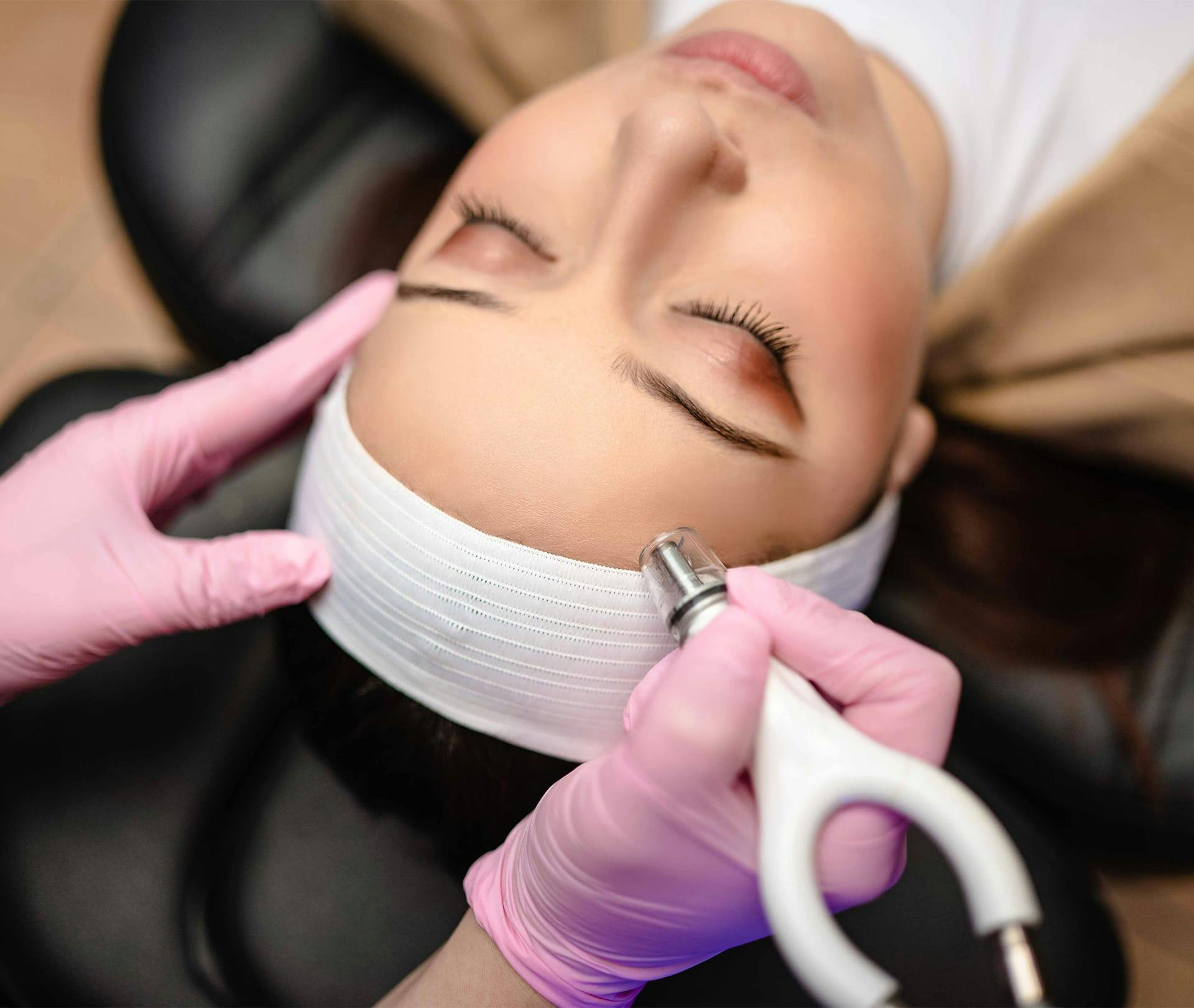 woman getting procedure on her forehead