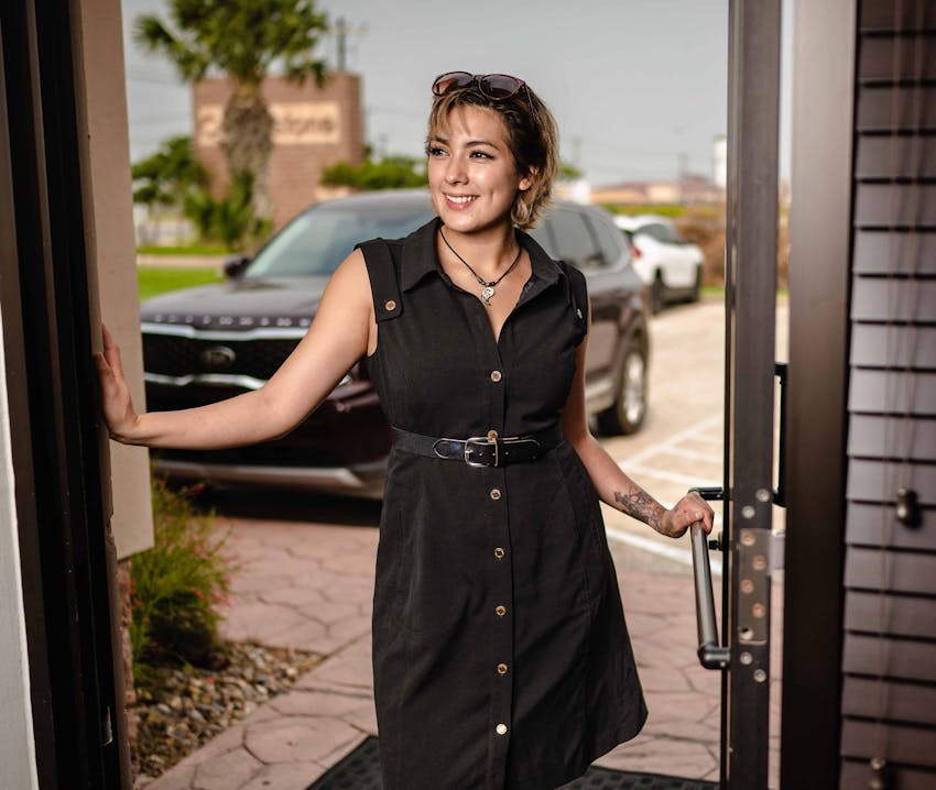 woman opening the door to the medspa