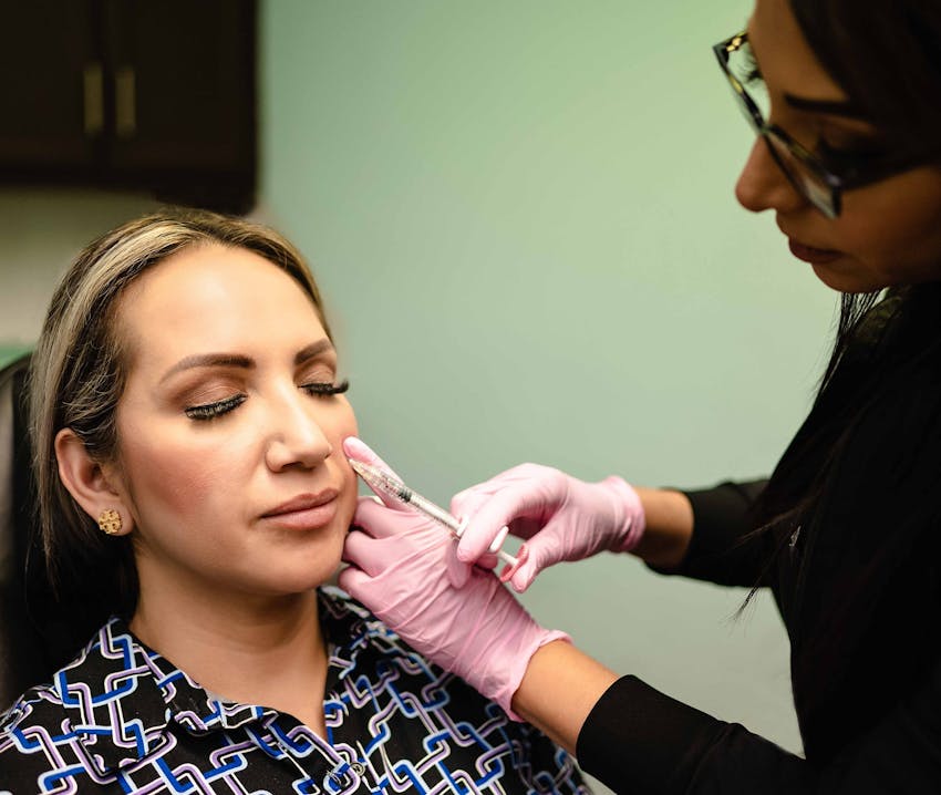 close up on woman's face with her hand resting on the side of her face