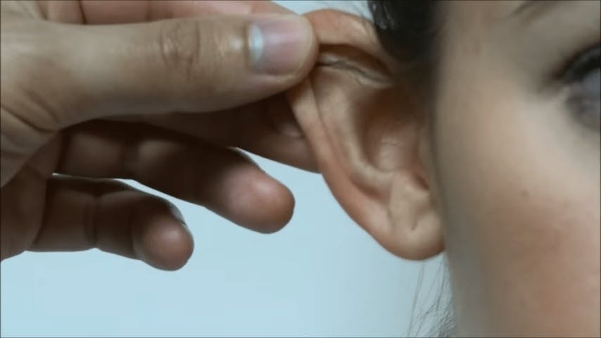 doctor examining patients ear