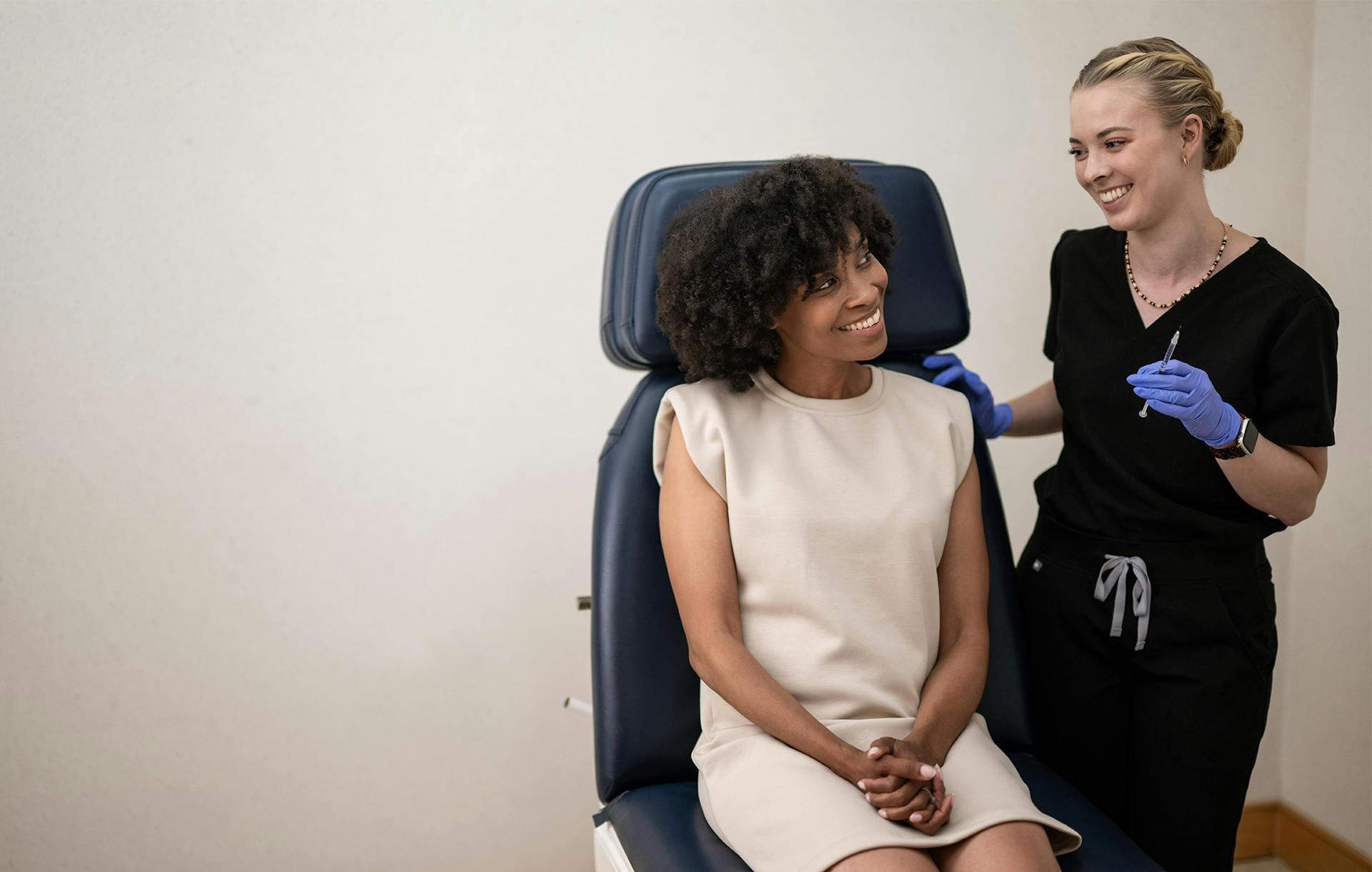 medical assitant and patient smiling