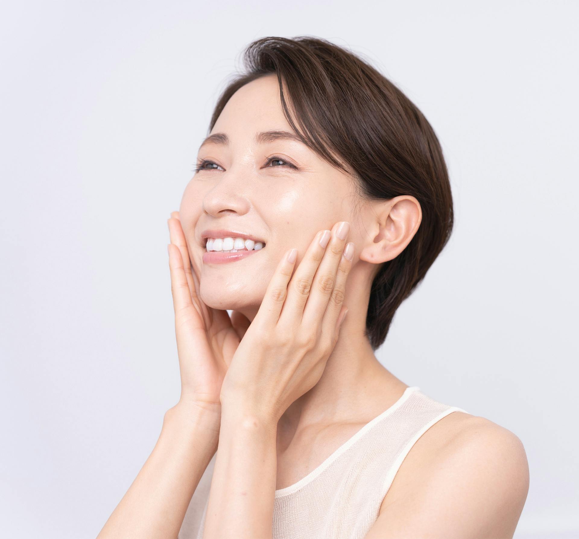 smiling woman with hands on face