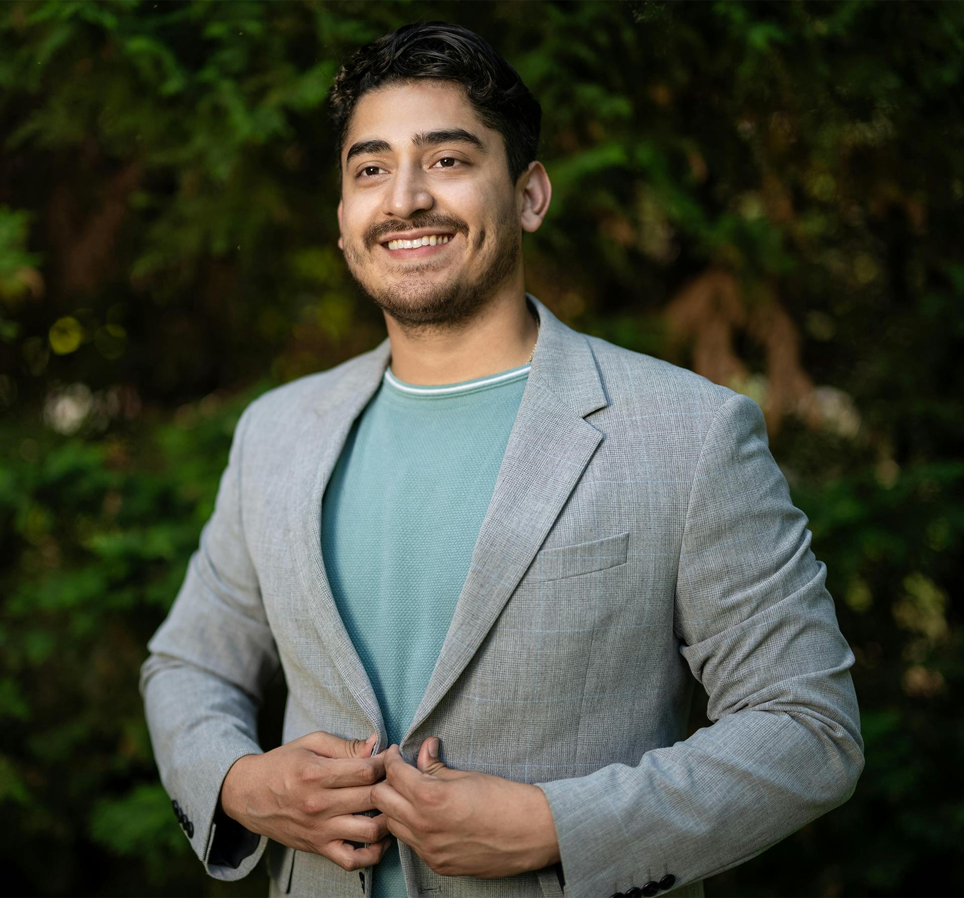 smiling man buttoning sports coat