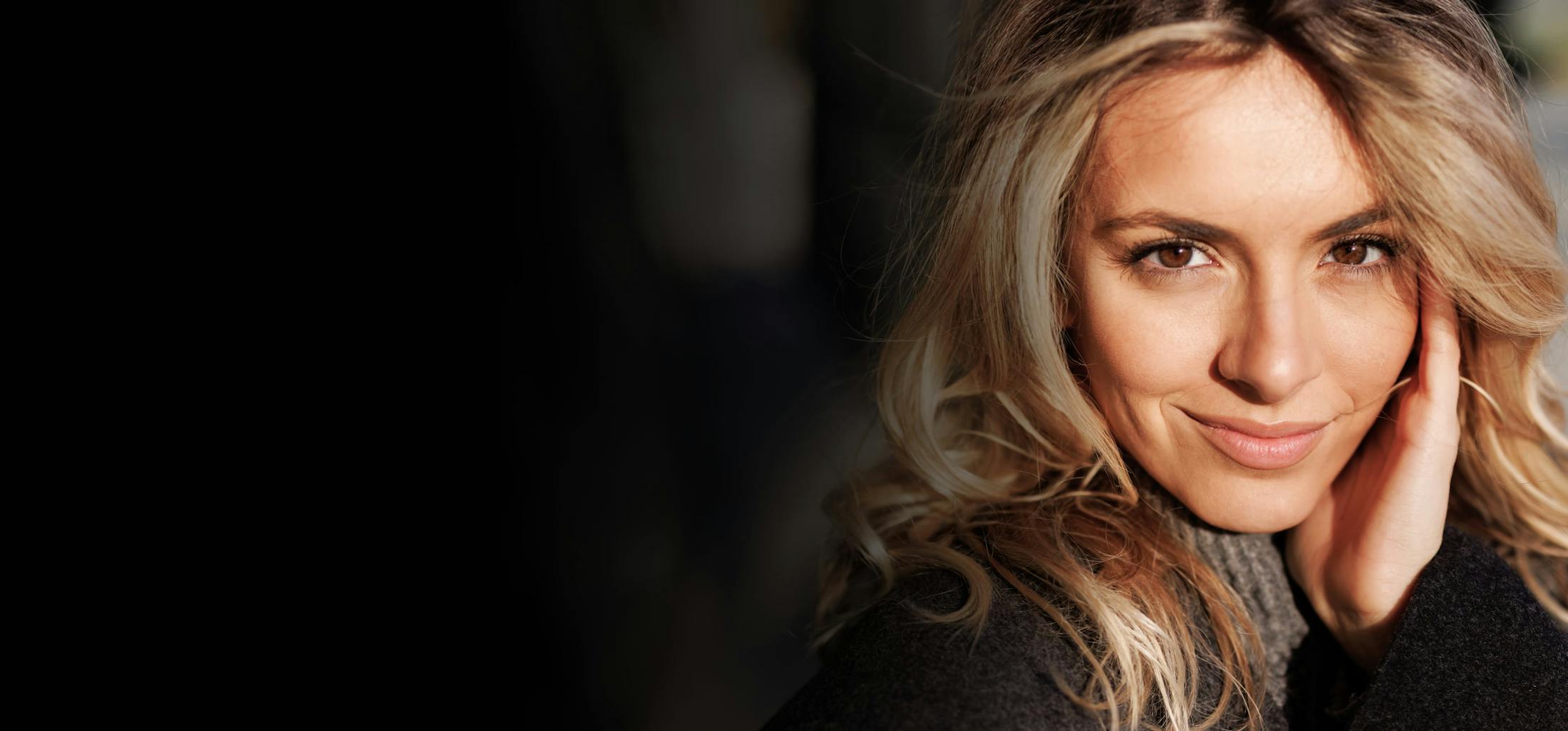 Woman with her hand on her cheek