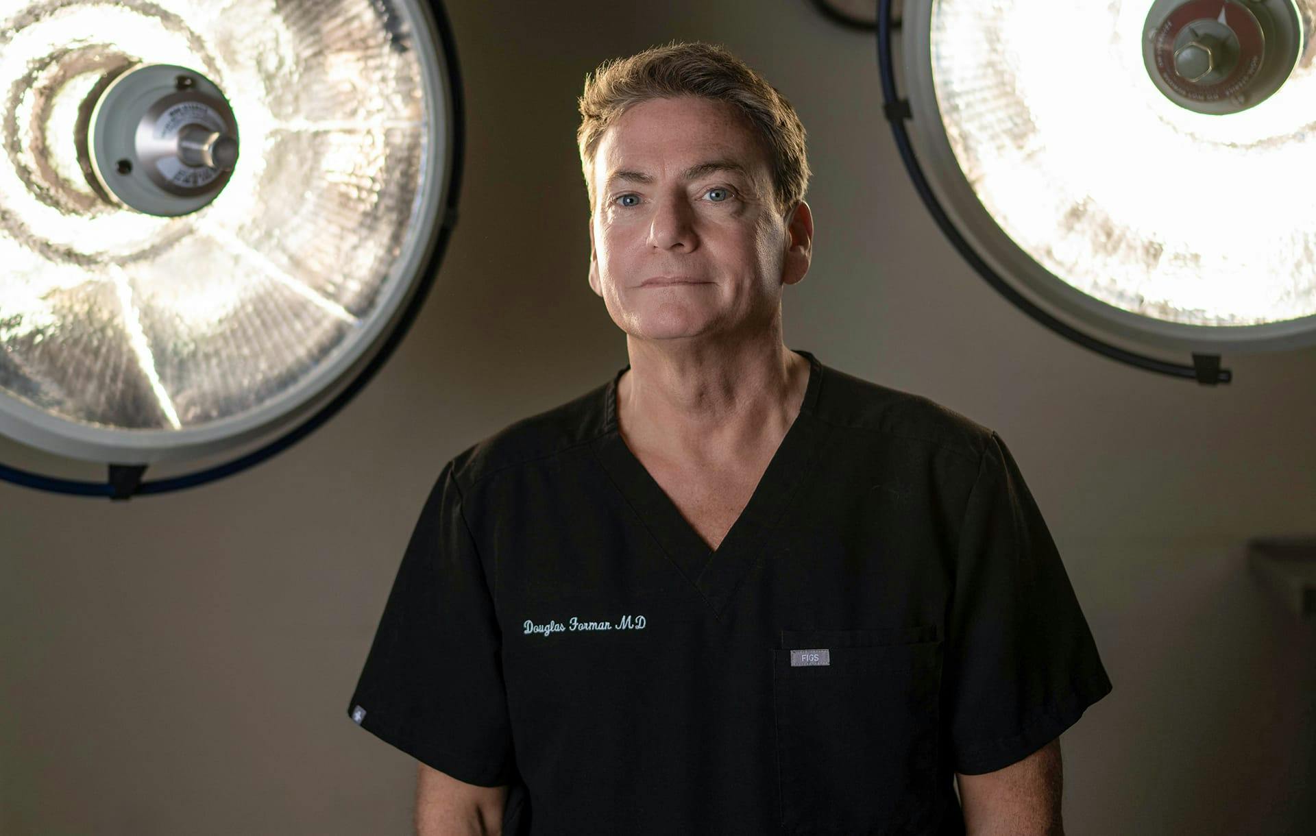 doctor standing infront of surgery lights