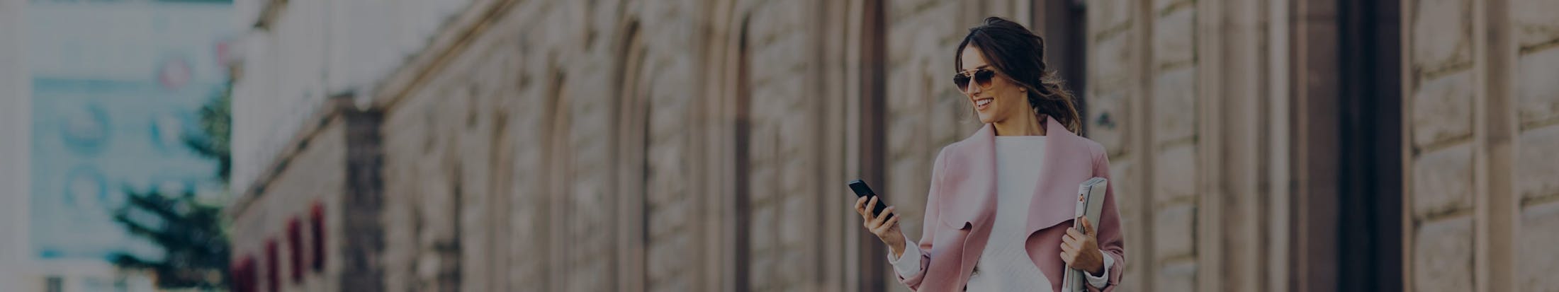 Woman walking while looking at her phone