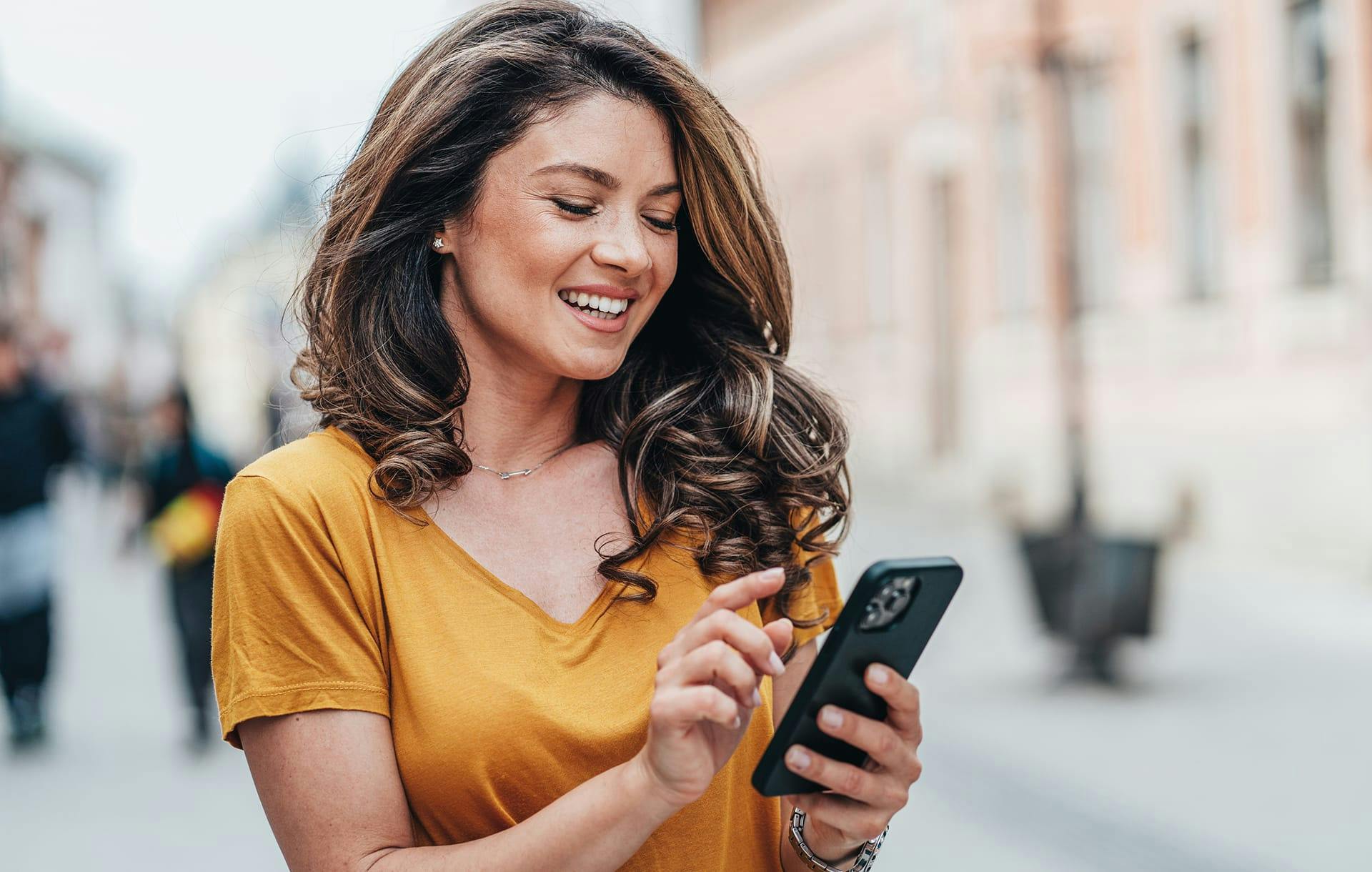 Woman smiling while on her phone