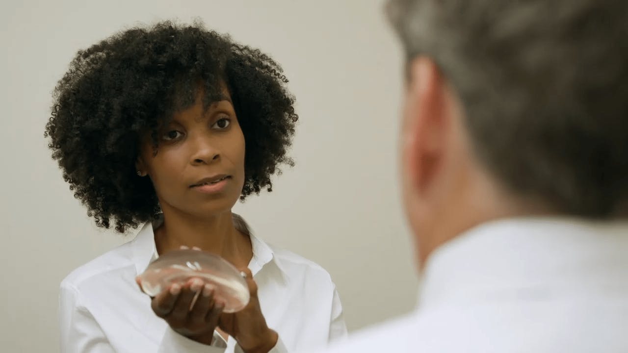 Woman holding an implant