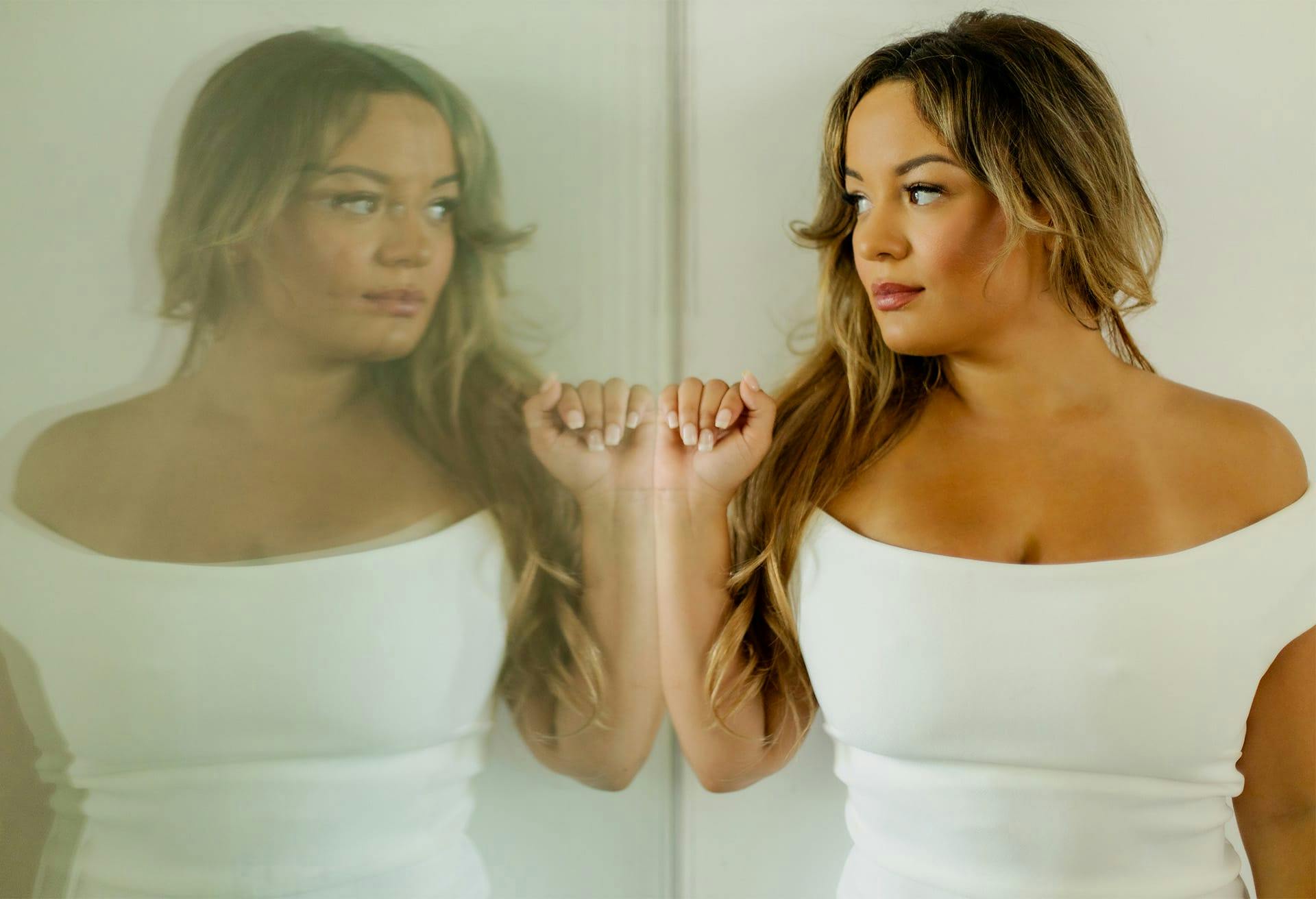 Brunette woman looking at reflection