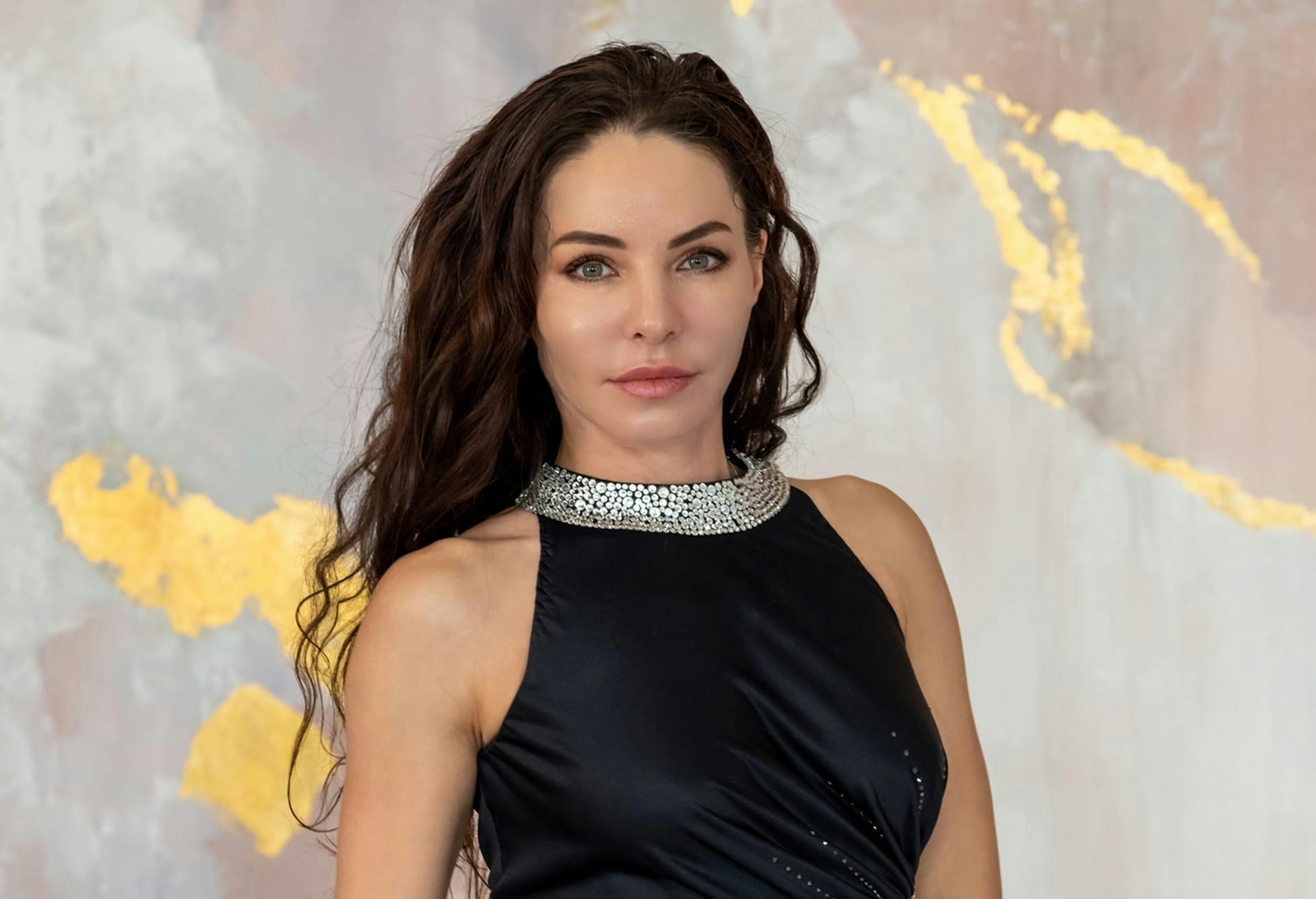 Woman in black dress with sparkly collar