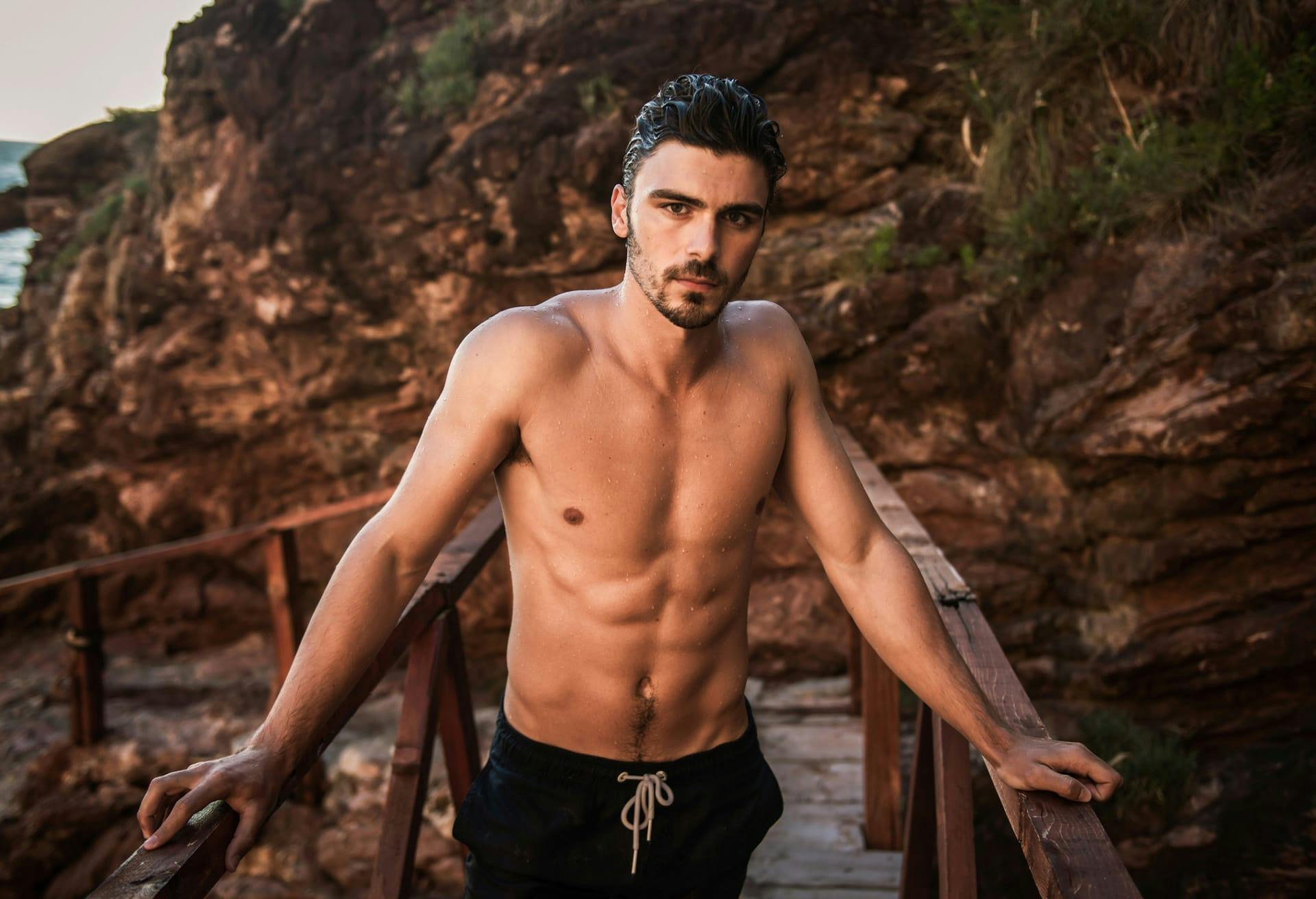 Shirtless man on bridge