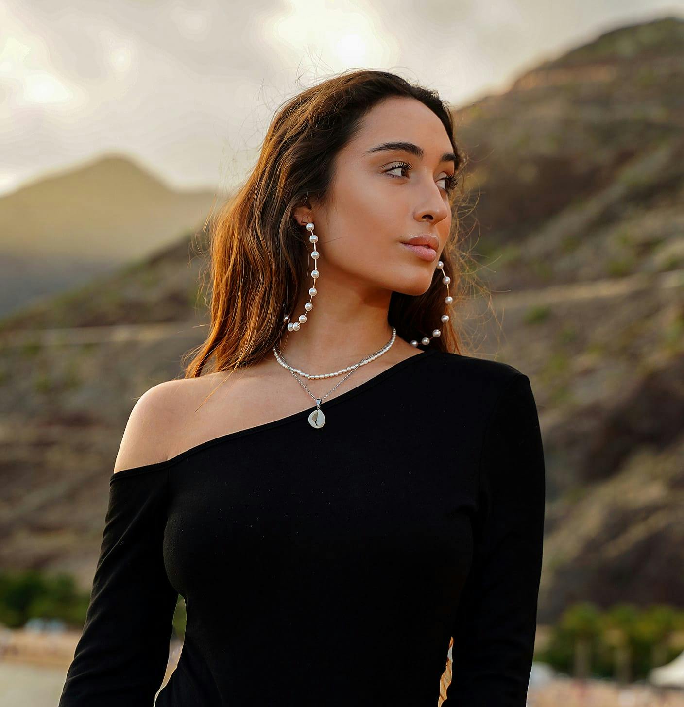Brunette woman with pearl hoop earrings