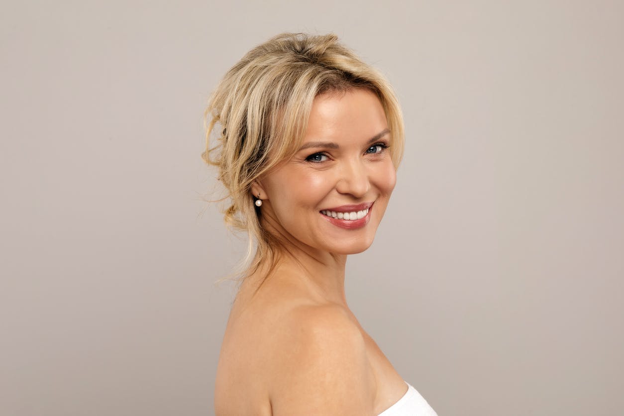 blonde woman with hair in a top bun