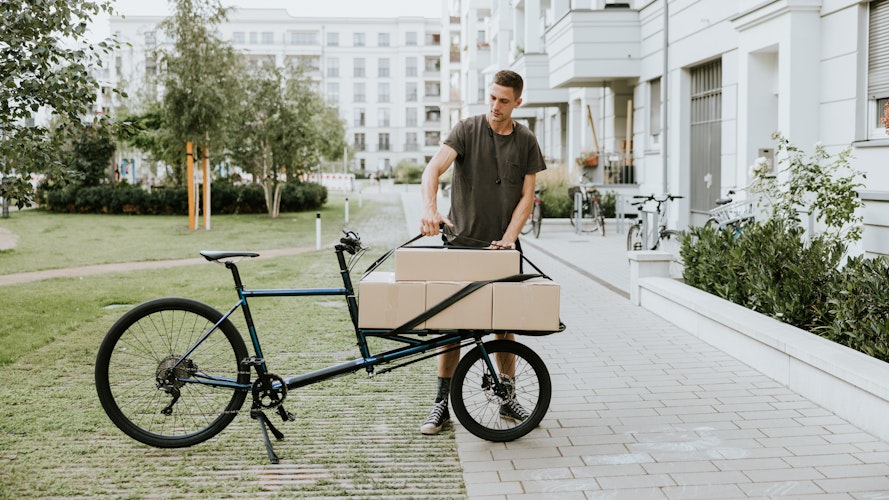 Electric cargo bike for delivery An electric cargo bike being loaded