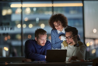 People looking at a laptop