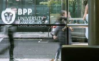 Student walking into building