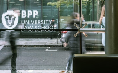 Student walking into building