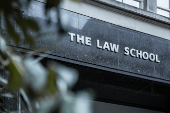 The front of a building with a sign saying "The Law School"