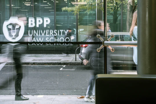 A window reflects BPP Univesrity Law School sign