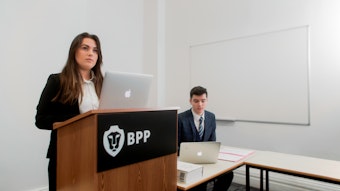 Woman at podium in mock court