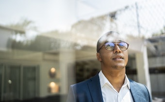 Man looking outside window