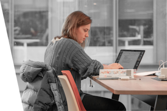 Female sitting at a desk on a laptop