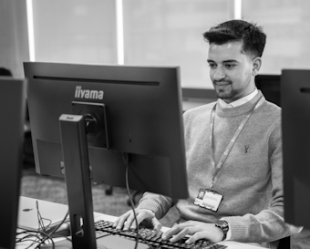 A student works on a desktop computer
