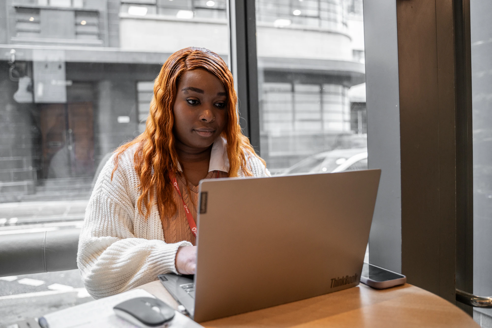 A woman sits in a cafe on a laptop computer