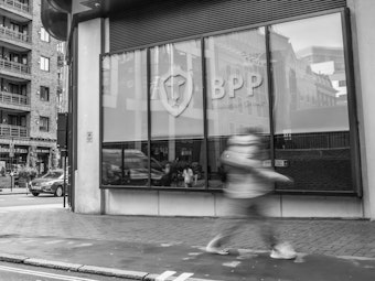 A person walks past a BPP centre window