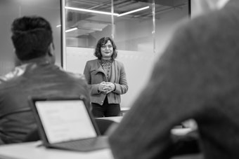 A tutor speaks to a class of students