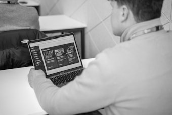A student looks at a laptop screen